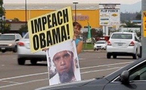Displaying the Impeach-Obama  and Obama-bin-Laden signs.